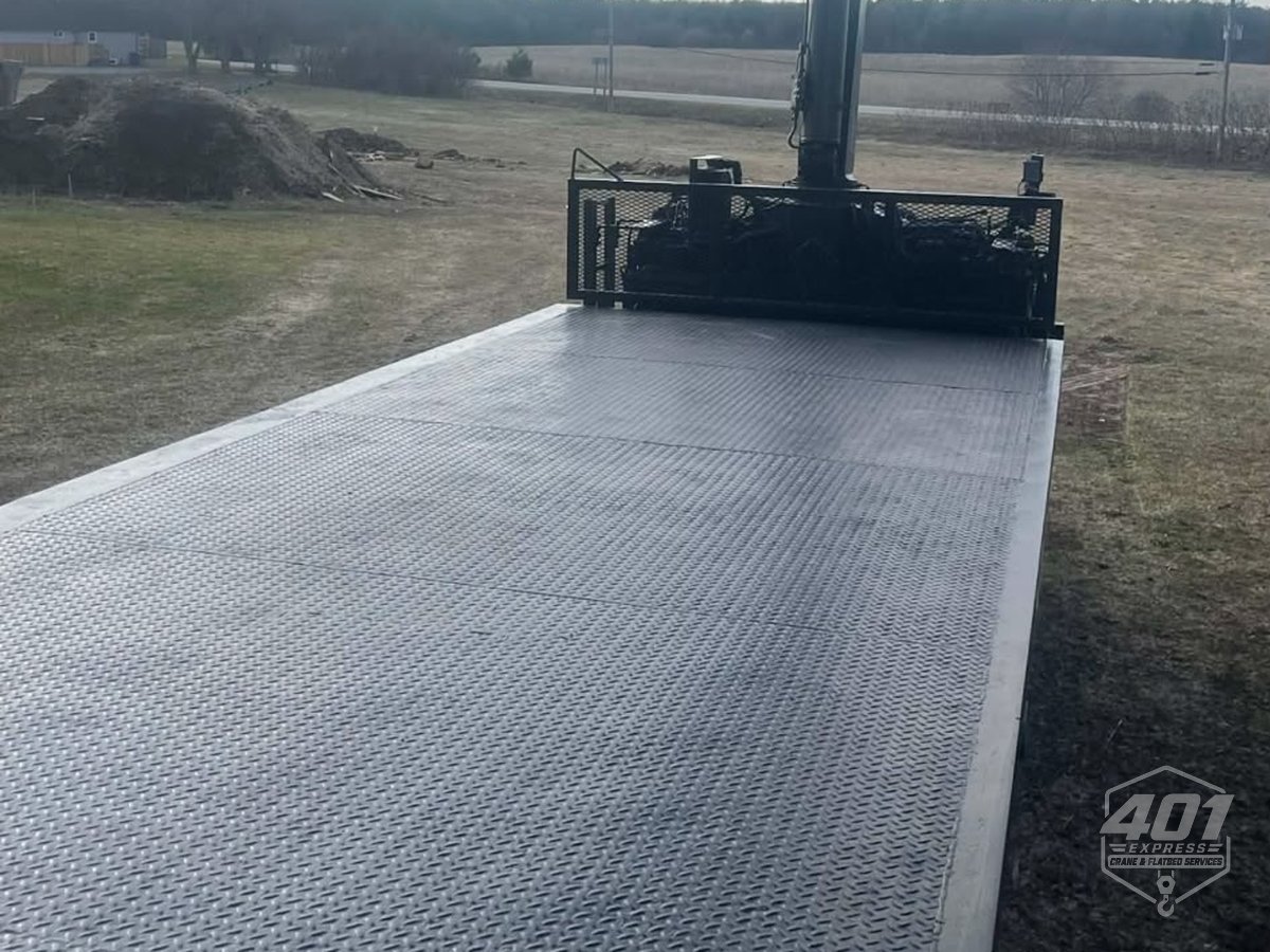 The 25 foot steel deck of the 401 Express flatbed crane truck, looking back toward the crane
