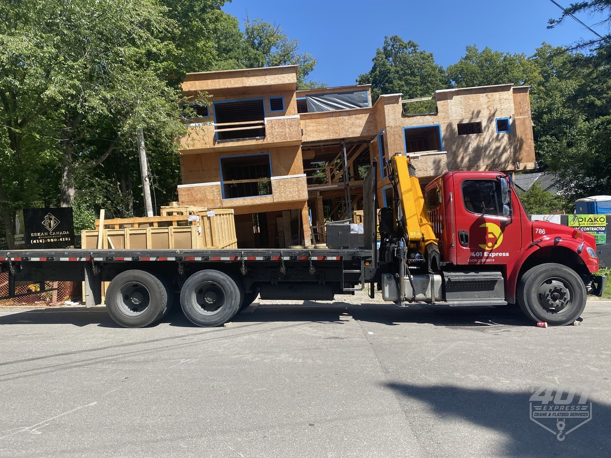 401 Express flatbed delivering building materials to a residential construction site in the GTA