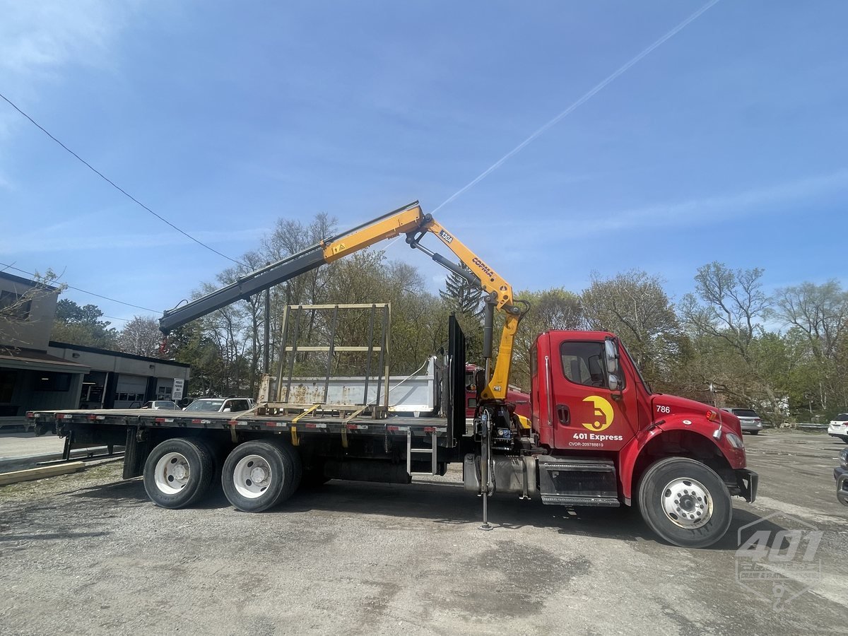 Side profile of the 401 Express flatbed truck with its knuckle-boom crane stowed