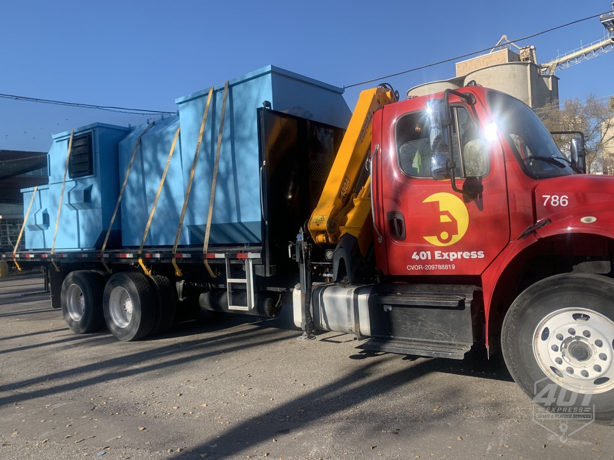Large air handling units strapped to the 401 Express crane truck flatbed for transport across the GTA