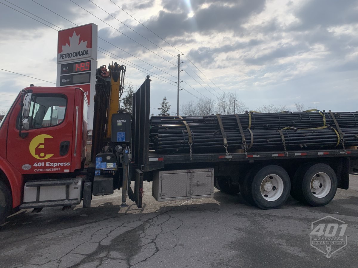 Bundled steel pipe strapped across the 401 Express 25 foot flatbed deck